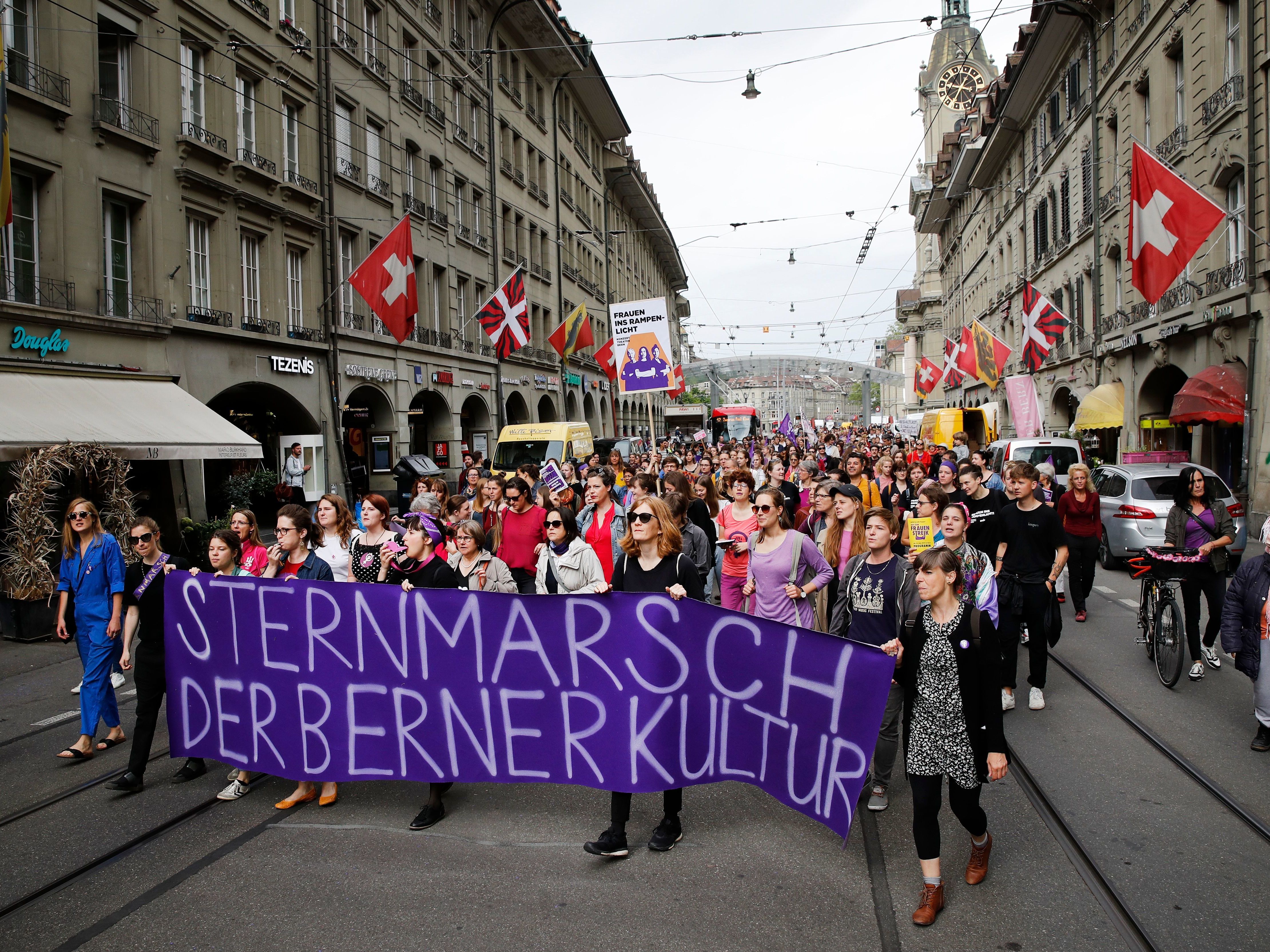 caption: People took to the streets Friday in the Swiss capital, Bern, during a nationwide strike for wage parity for women.