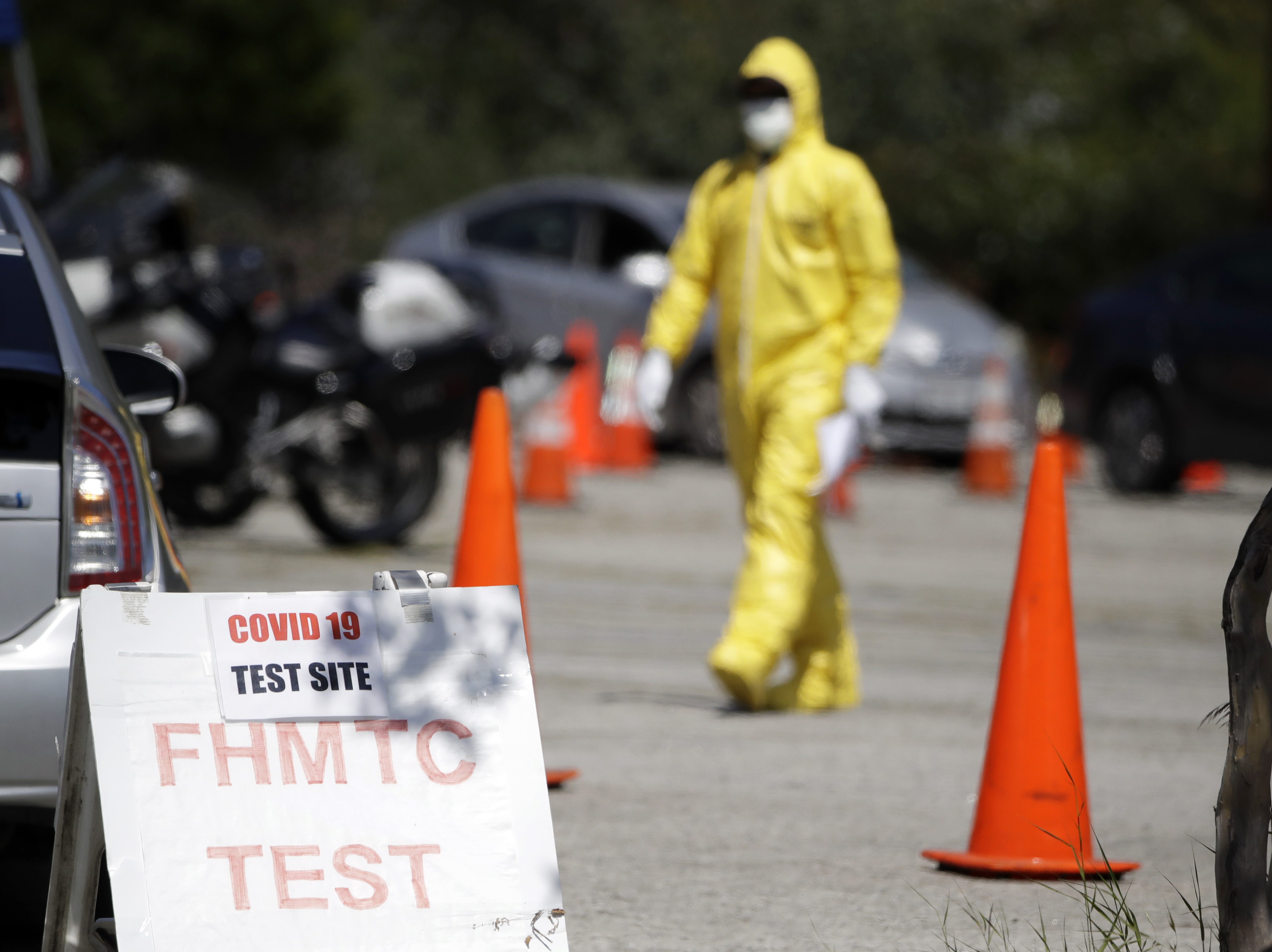 caption: A person wearing protective equipment at a coronavirus testing site for first responders, on Monday in Los Angeles.