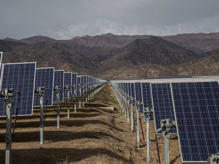 caption: Solar panels at Chile's Quilapilún energy plant are part of a joint venture by Chile and China. China has been investing heavily in renewable energy technology.