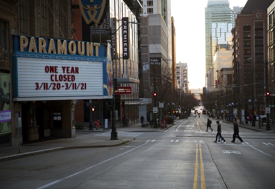 caption: The Paramount Theatre marquee reads 'One Year Closed 3/11/20 - 3/11/21,' as the sun sets on Thursday, March 11, 2021, along Pine Street in Seattle.