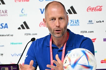 caption: USA coach Gregg Berhalter speaks during a press conference at the Qatar National Convention Center in Doha on December 2, 2022, on the eve of the USA's World Cup soccer match against the Netherlands.