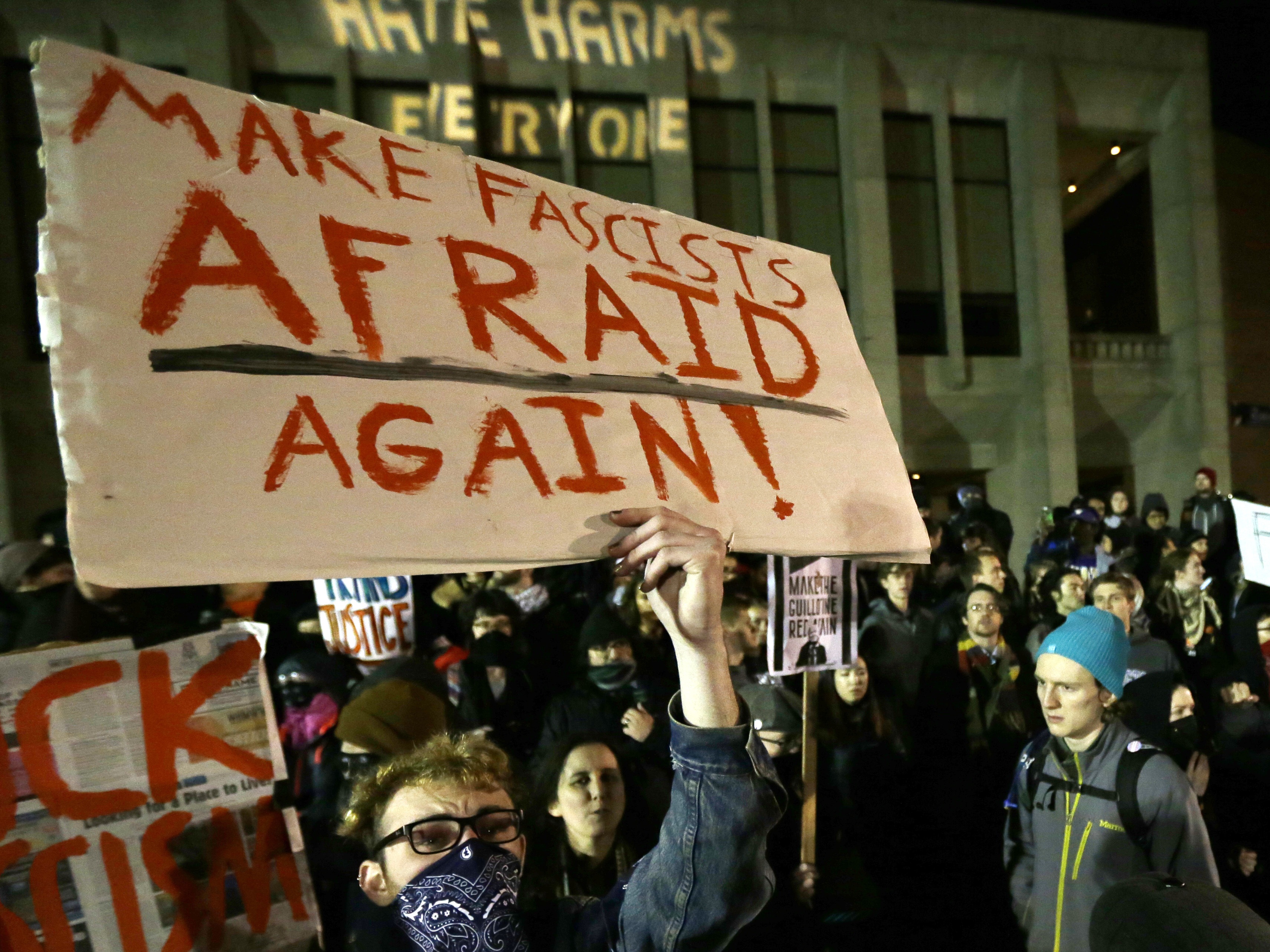 caption: A protester holds a sign that reads "Make Fascists Afraid Again!" during a demonstration at the University of Washington on Jan. 20, 2017, in Seattle.