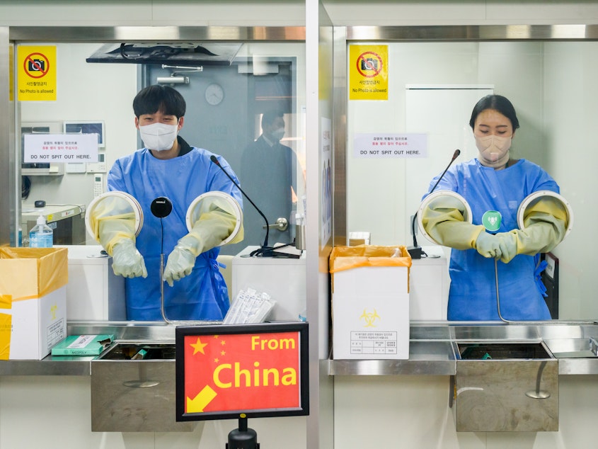 caption: It's COVID testing time at Incheon International Airport, west of Seoul, South Korea. Arrivals from China must now submit to a PCR test.