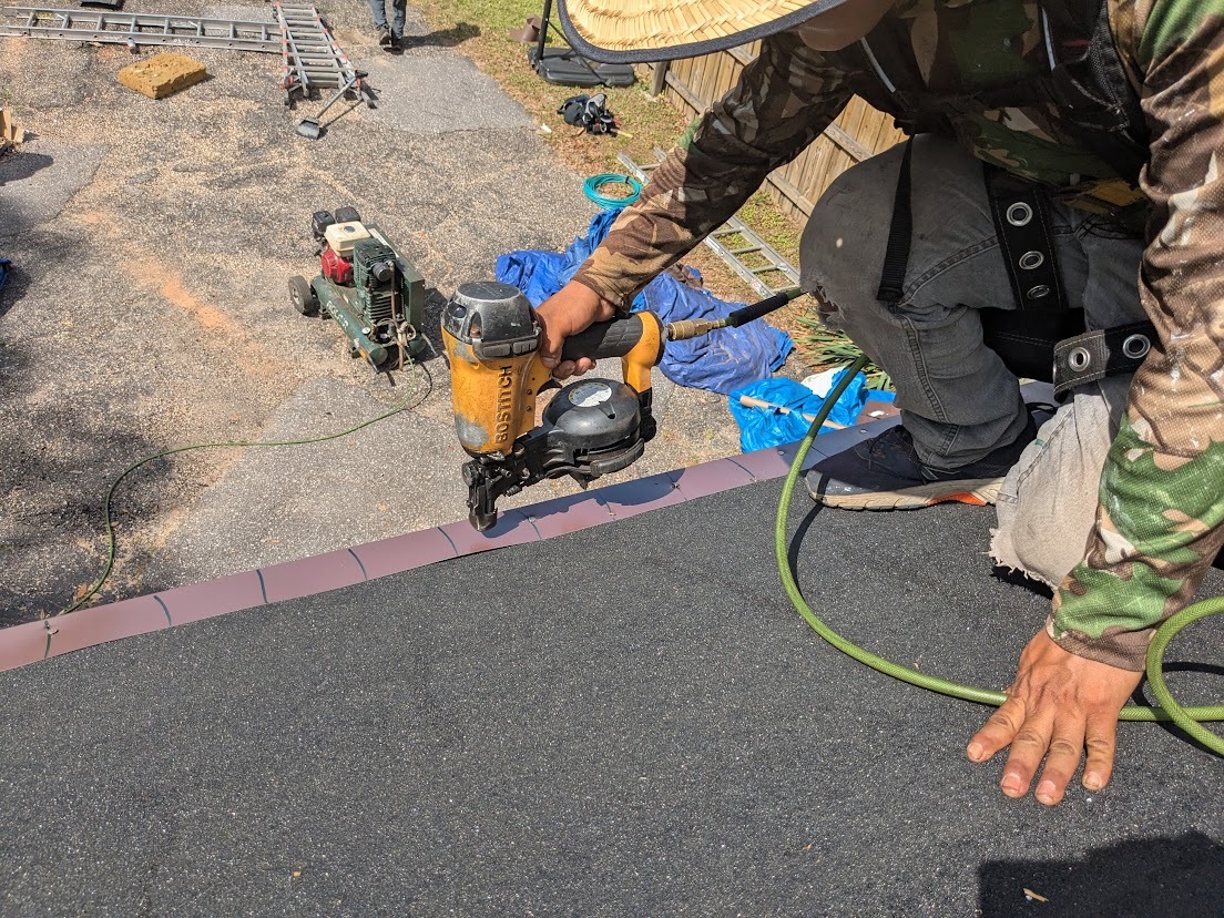 caption: Contractors install a roof in Mobile County, Ala., designed to better withstand hurricanes. Other states are adopting similar programs, offering insurance discounts to encourage disaster preparation.