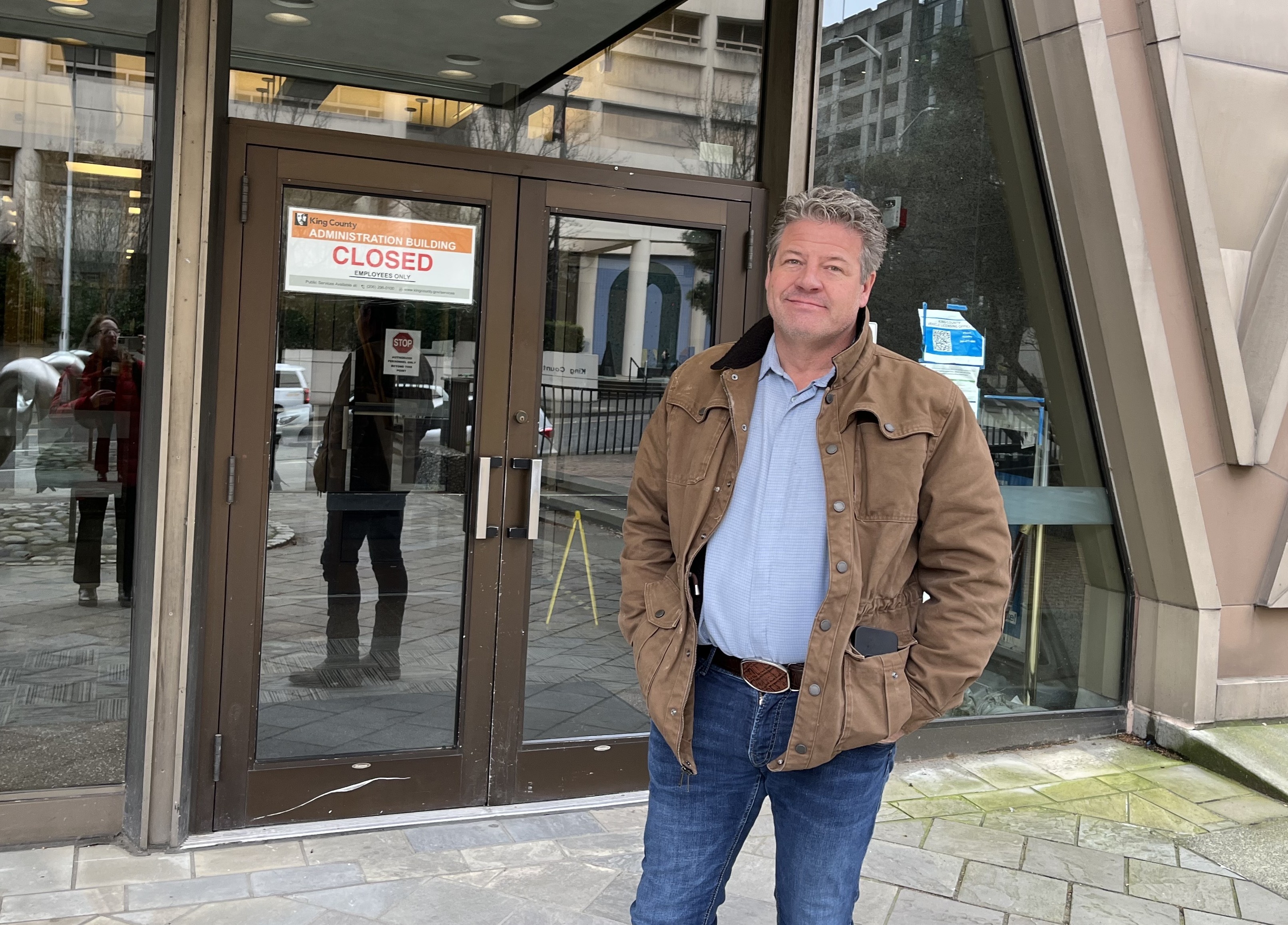 caption: King County Councilmember Reagan Dunn outside the closed Administration Building in downtown Seattle, March 12, 2026. 
