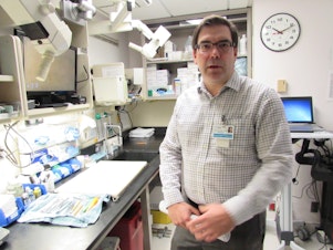 caption: NWBio Trust director Dr. Stephen Schmechel shows where tissue samples are processed, steps from the operating room at the UW Medical Center.