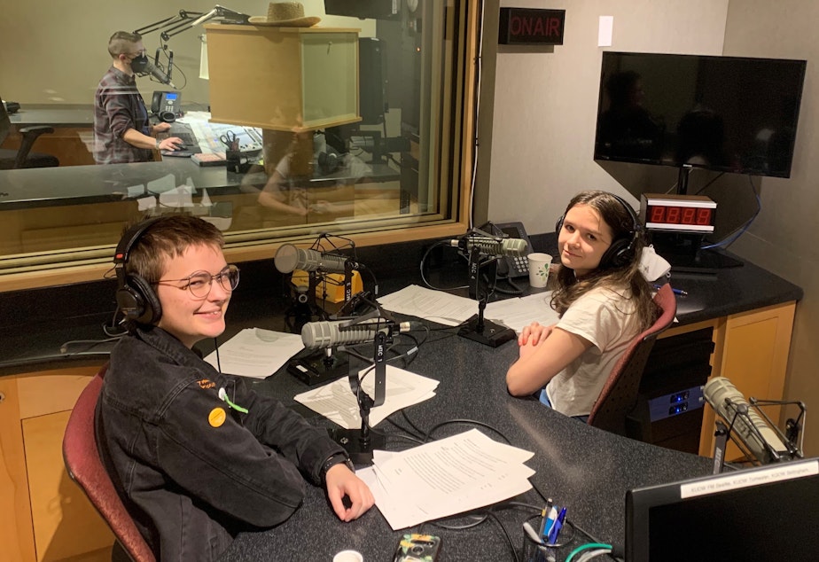 caption: Gideon Hall and Ada Walther, graduates of RadioActive's 2022 Intro to Radio Journalism Workshop and the hosts of this showcase, in the KUOW studios.