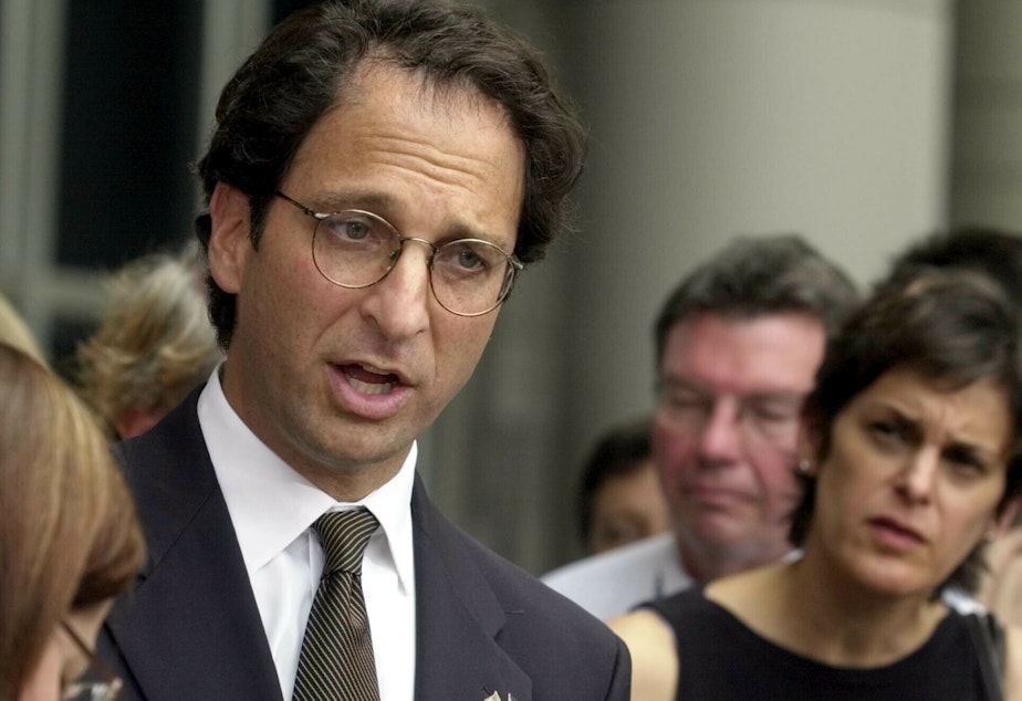 caption: Prosecutor Andrew Weissmann talked with reporters outside the federal courthouse in Houston in 2002. His new book reflects on the past and potential future of the Justice Department.