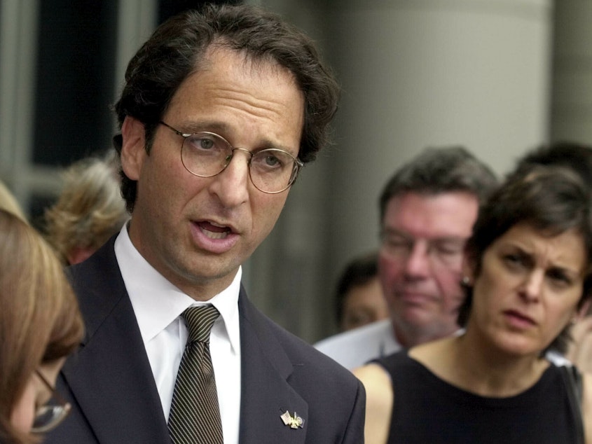 caption: Prosecutor Andrew Weissmann talked with reporters outside the federal courthouse in Houston in 2002. His new book reflects on the past and potential future of the Justice Department.