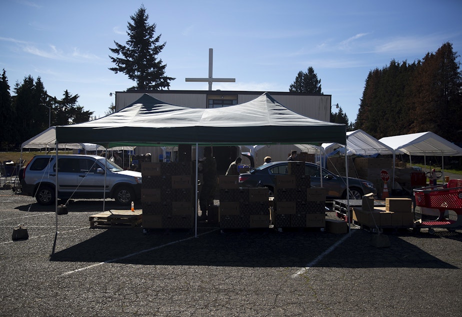 caption: Vehicles line up on Tuesday, September 22, 2020, at the Tukwila Pantry Food Bank on South 140th Street in Tukwila.