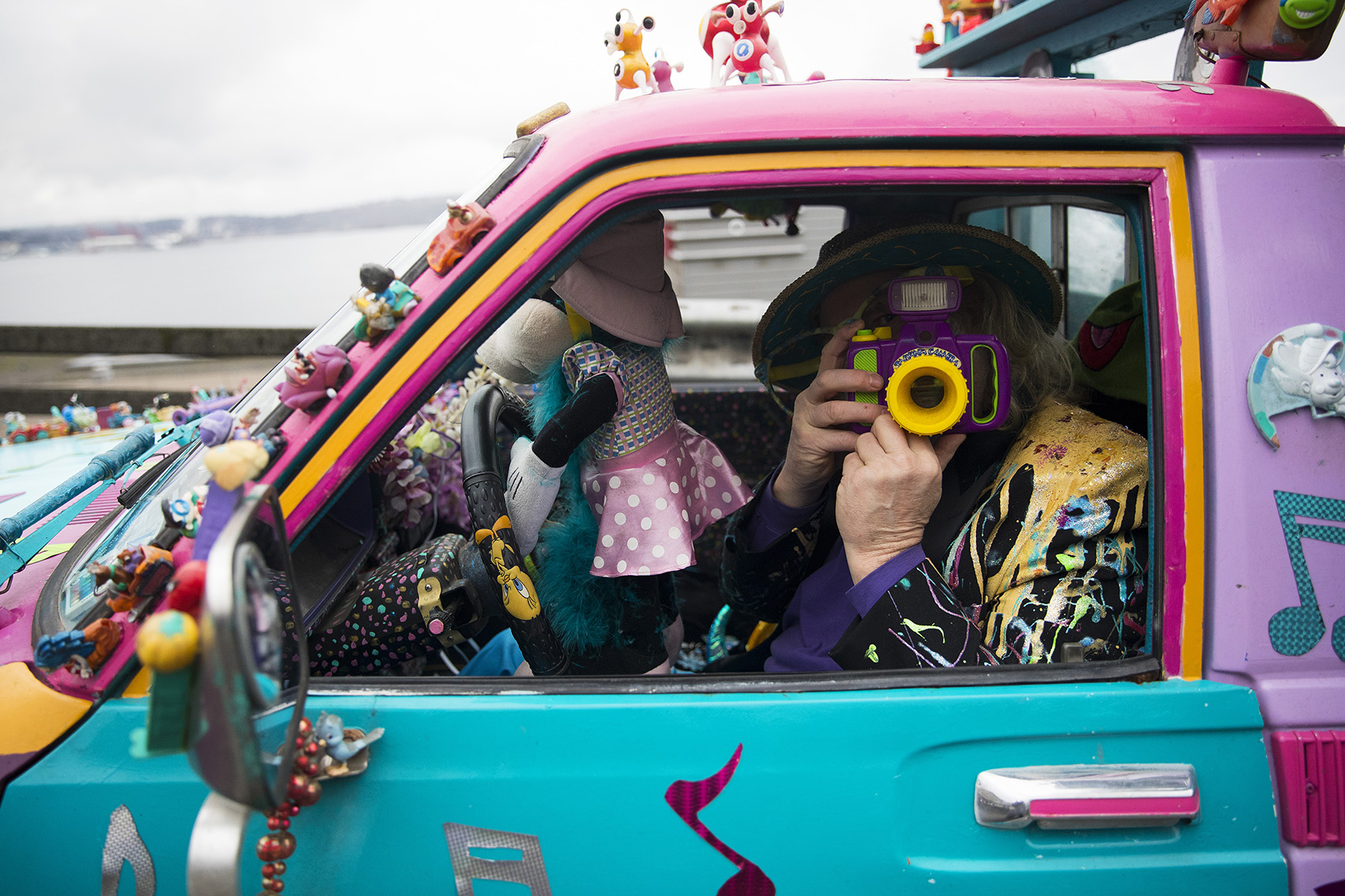 caption: Ranger Kidwell-Ross holds up a toy camera in the driver seat of his 'Toynota' on Saturday, February 2, 2019, during the Hello Goodbye Viaduct Arts Festival on the Alaskan Way Viaduct in Seattle. 