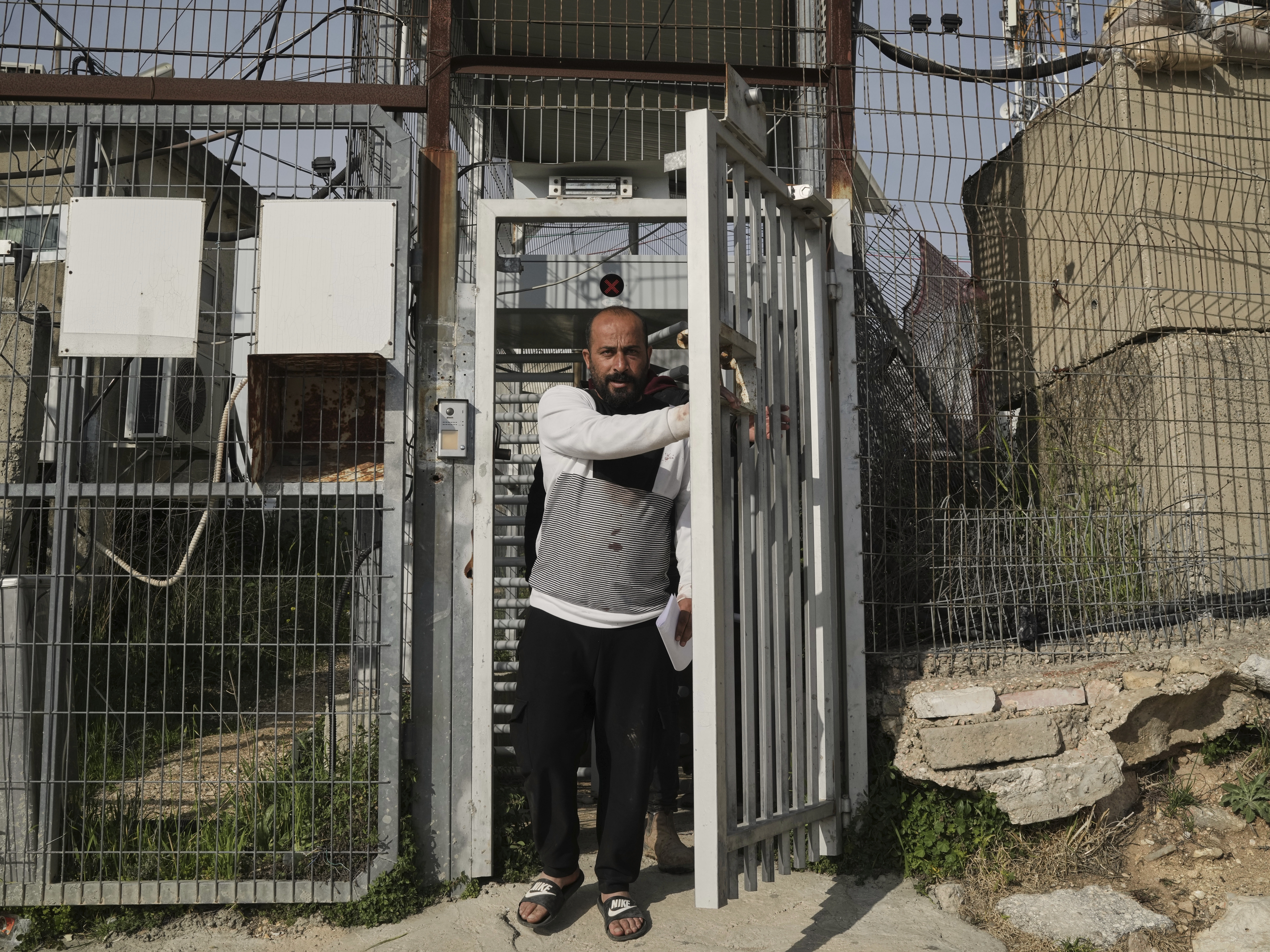 caption: Hamdan Ballal, an Oscar-winning Palestinian co-director of <em>No Other Land</em>, is released from a police station in the West Bank settlement of Kiryat Arba on Tuesday, a day after being detained by the Israeli army following an attack by Jewish settlers.