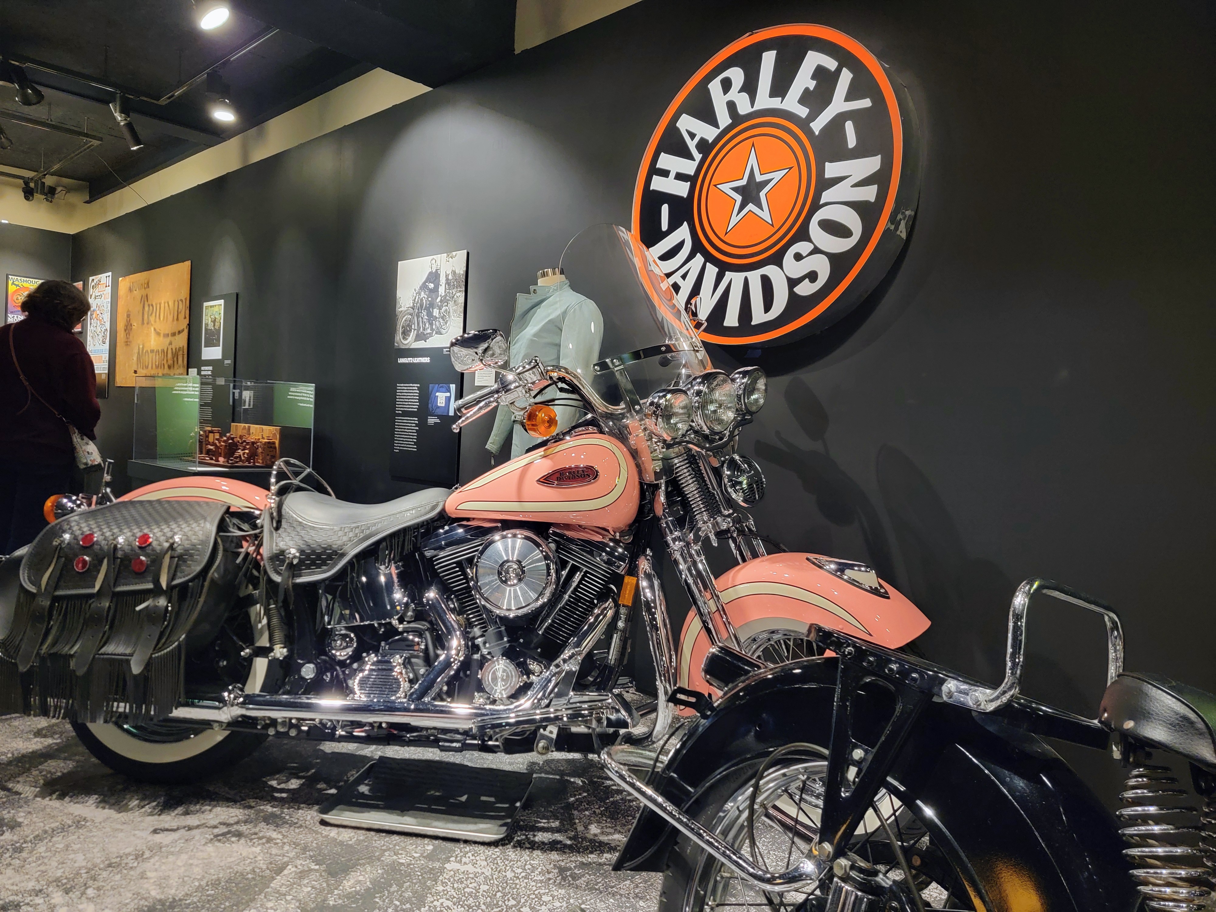 caption: A pink Harley owned by Beverly Thompson, founder of Eastside Harley-Davidson, is one of the biggest bikes in the MOHAI "Kickstands Up!" motorcycle exhibit in Seattle.