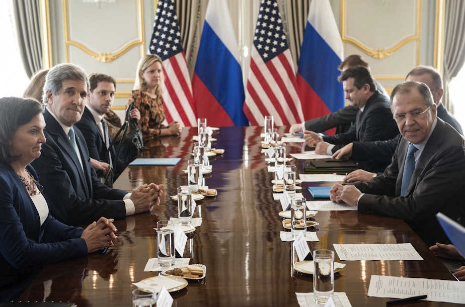 caption: U.S. Secretary of State John Kerry, second left, and Russian Foreign Minister Sergey Lavrov, right, wait to start their meeting at Winfield House, the residence of the U.S. ambassador, in London, Friday March 14, 2014. 