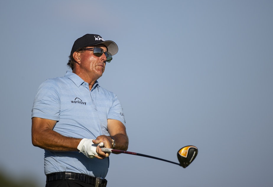 caption: Phil Mickelson, seen at the Charles Schwab Series at Ozarks National in 2020, says he "used words I sincerely regret" in an interview about a Saudi-financed golf league.