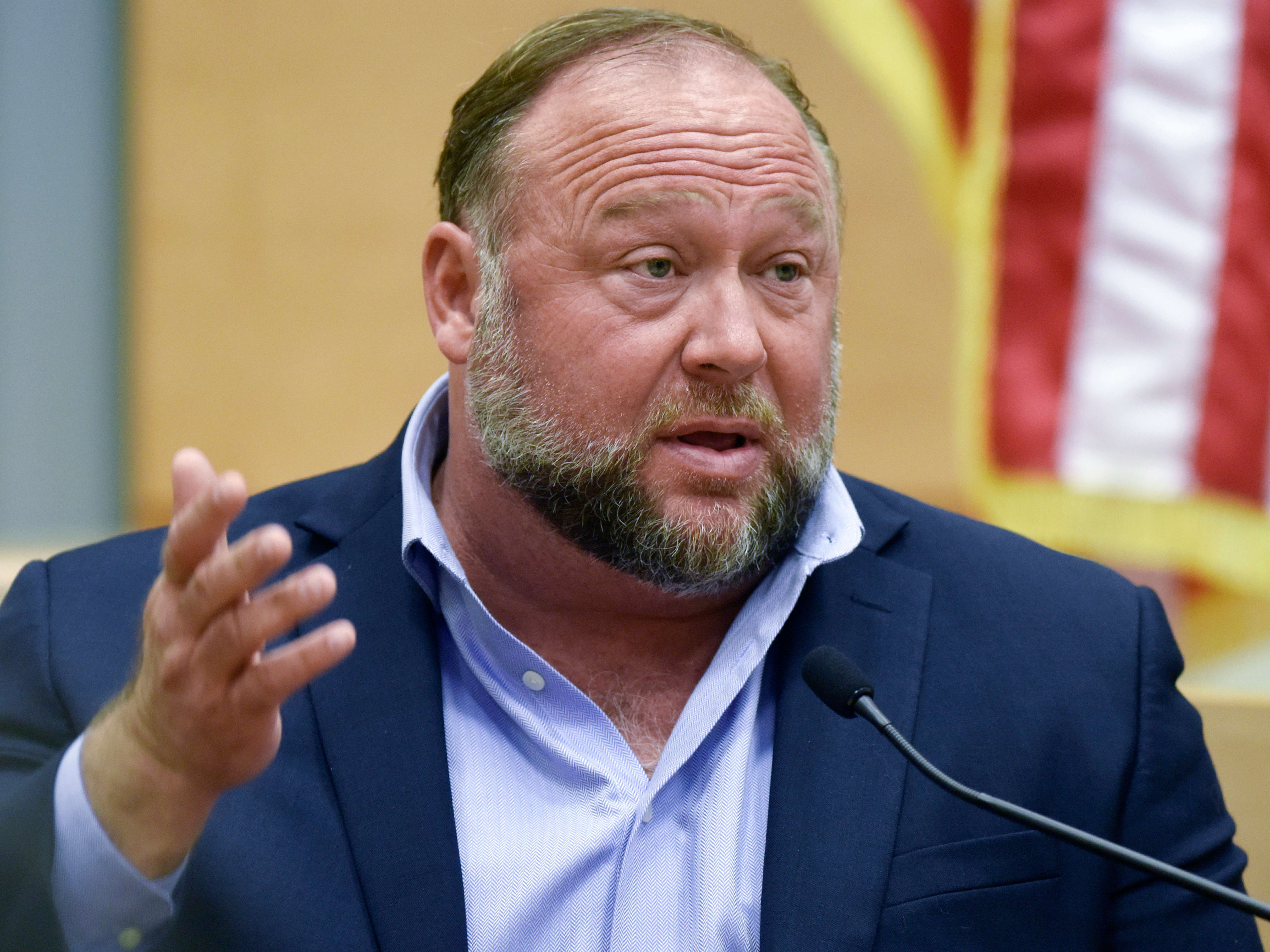 caption: Conspiracy theorist Alex Jones is seen taking the witness stand to testify at the Sandy Hook defamation damages trial at Connecticut Superior Court in Waterbury, Conn., Sept. 22, 2022.