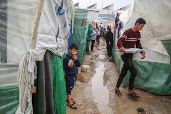 caption: Palestinian children, having fled the Israeli bombing of the northern Gaza Strip in response to the Oct. 7 attack by Hamas, are living in temporary shelters at Al-Aqsa Martyrs Hospital. Global health groups say they are doing what they can to keep a lid on infectious diseases amid crowded, unsanitary conditions and a devastated health-care system.