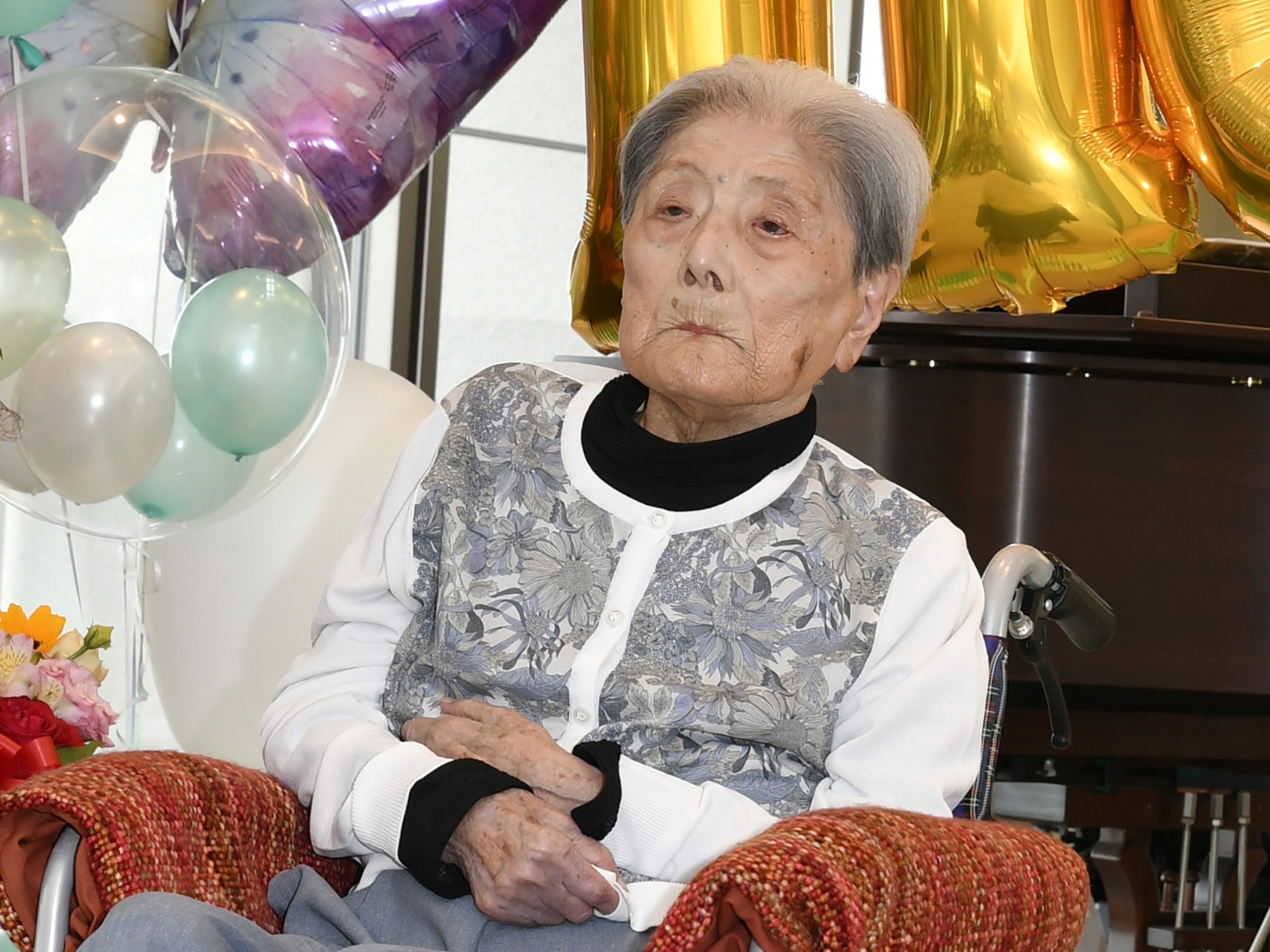 caption: This photo provided by Ashiya City shows Tomiko Itooka, being celebrated for her 116th birthday at the nursing home she lives in Ashiya, western Japan, on May 23, 2024.