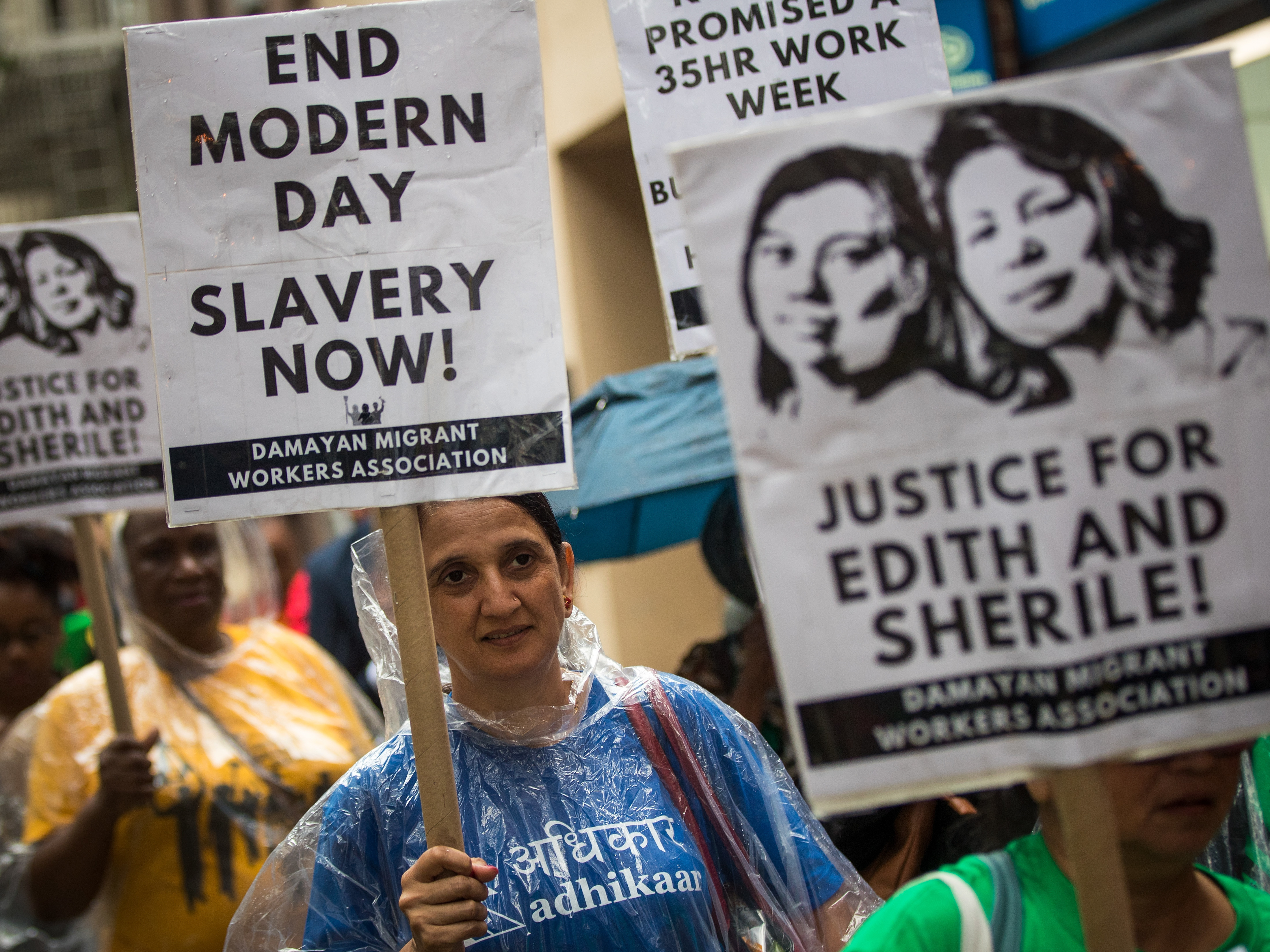 caption: Activists march toward the German consulate during a rally to support two Filipina domestic workers in their lawsuit against a German diplomat.