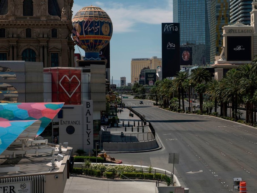 caption: A car drives down an otherwise empty Las Vegas Strip amid the coronavirus pandemic on May 8.