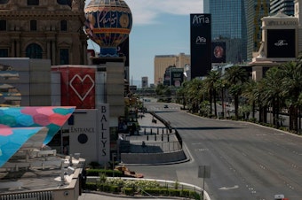 caption: A car drives down an otherwise empty Las Vegas Strip amid the coronavirus pandemic on May 8.