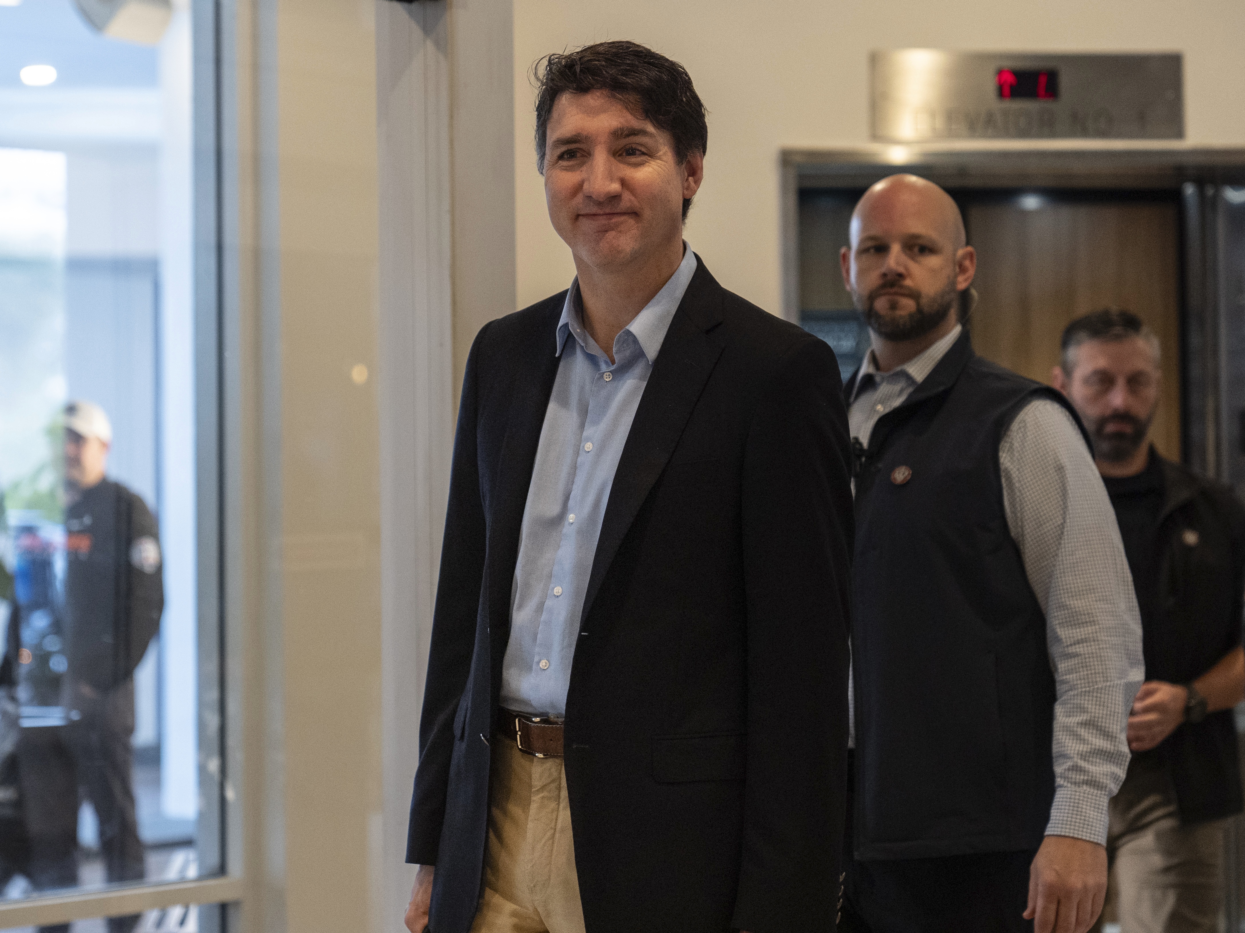 caption: Canada Prime Minister Justin Trudeau walks through the lobby of the Delta Hotel by Marriott in West Palm Beach, Fla., on Saturday.
