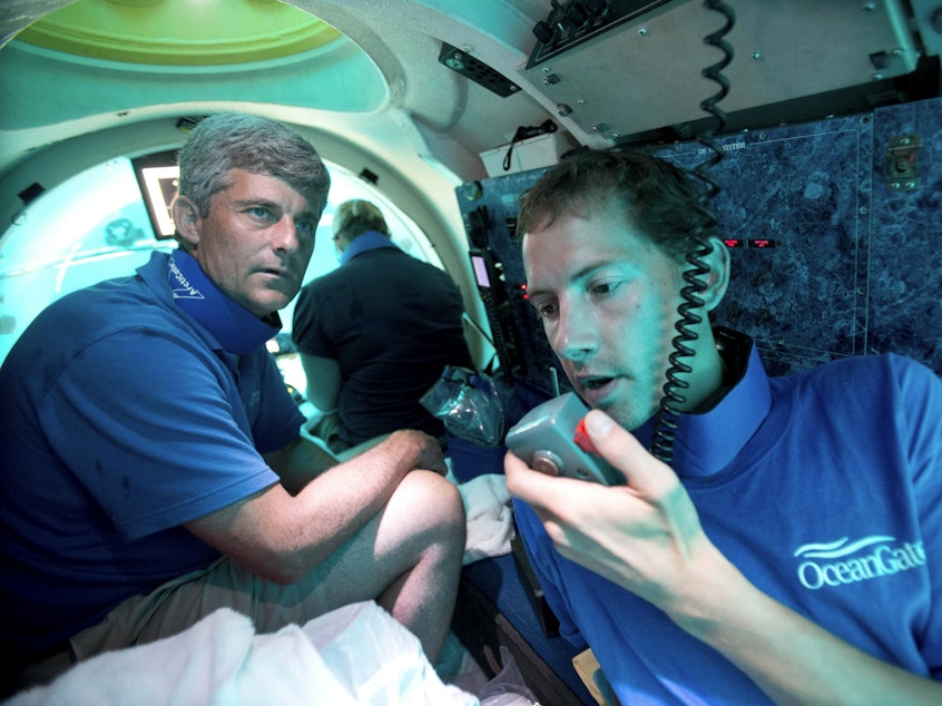 caption: Submersible pilot Randy Holt and Stockton Rush, CEO and co-founder of OceanGate, dive in the company's Antipodes submersible off the Florida coast in 2013. Rescuers are racing to find a missing OceanGate submersible before the oxygen supply runs out for five people, including Rush, who were on a mission to document the wreckage of the Titanic.