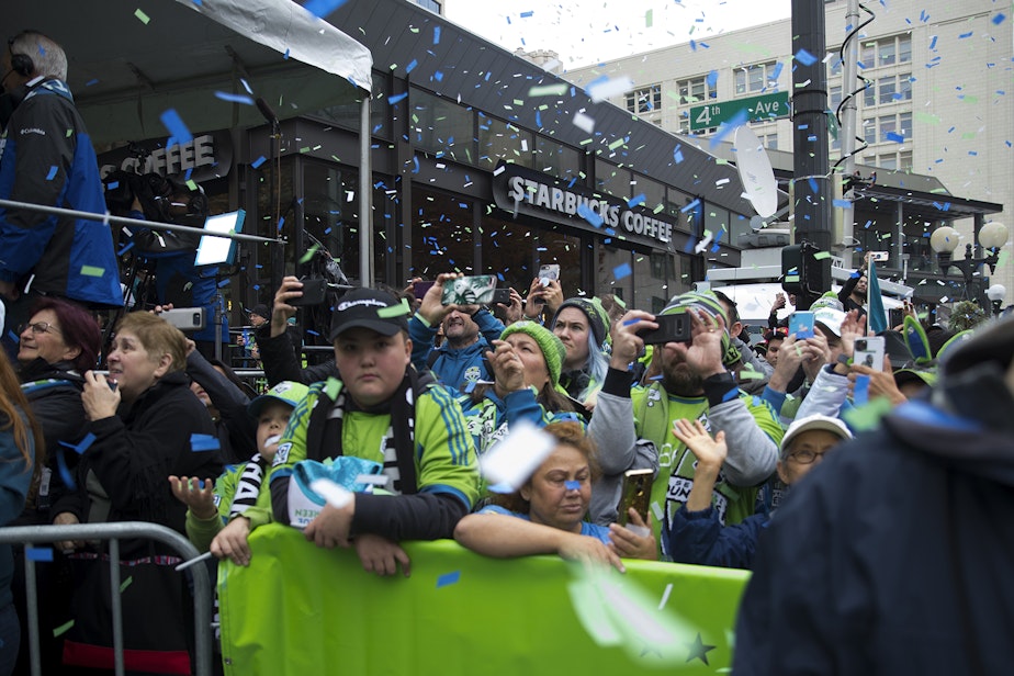 caption: Confetti rains down on Seattle Sounders fans on Tuesday, November 12, 2019, during the start of the MLS Cup Champions Parade and Rally near Westlake Park in Seattle.