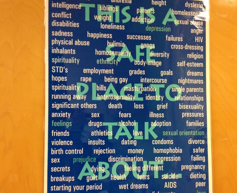 caption: A poster at Rainier Beach High School's teen clinic lets students know they have a safe place to talk.