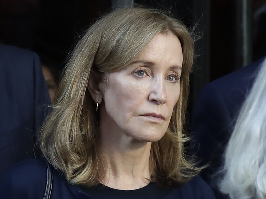 caption: Actress Felicity Huffman leaves federal court after her sentencing in a nationwide college admissions bribery scandal in Boston last month.