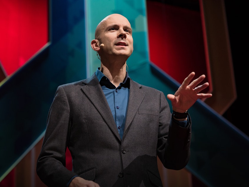 caption: Tim Harford on the TED stage.
