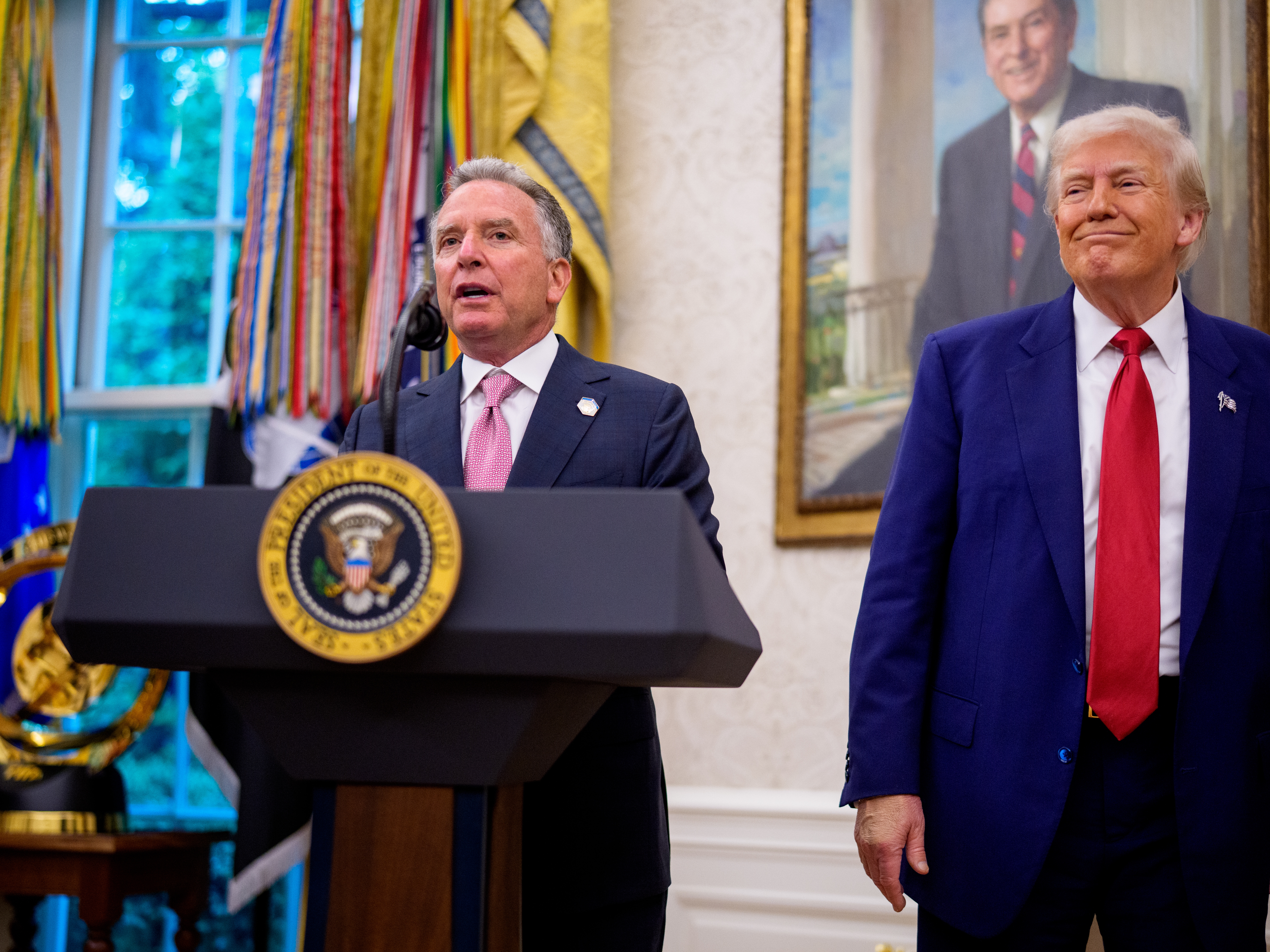 caption: Steve Witkoff, flanked by President Trump, speaks at the White House on May 28.