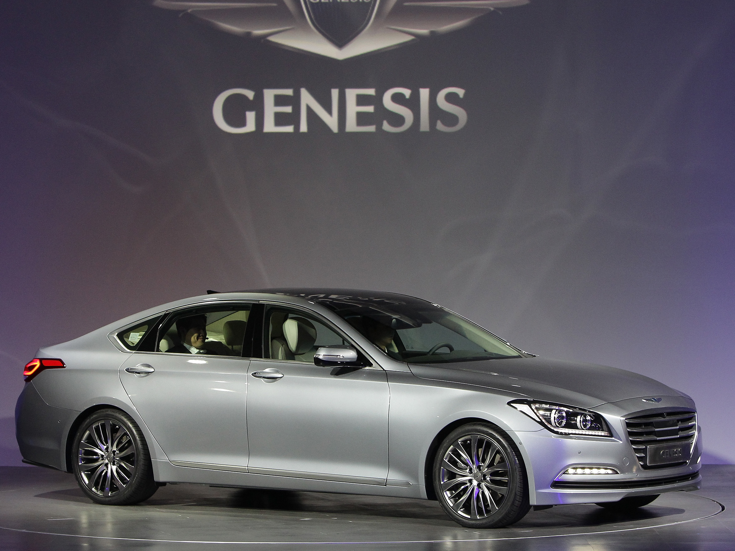 caption: A woman in Missouri says a man she had sex with in a Hyundai Genesis infected her with HPV through neglect — and she wants his insurance company to cover her medical costs and other damages. Here, Hyundai representatives display the 2014 model of the Genesis.