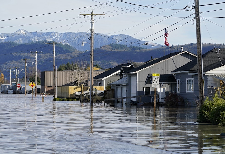 caption: Floodwater inundates homes along a road Wednesday, Nov. 17, 2021, in Sumas, Wash. An atmospheric river—a huge plume of moisture extending over the Pacific and into Washington and Oregon—caused heavy rainfall in recent days, bringing major flooding in the area. 