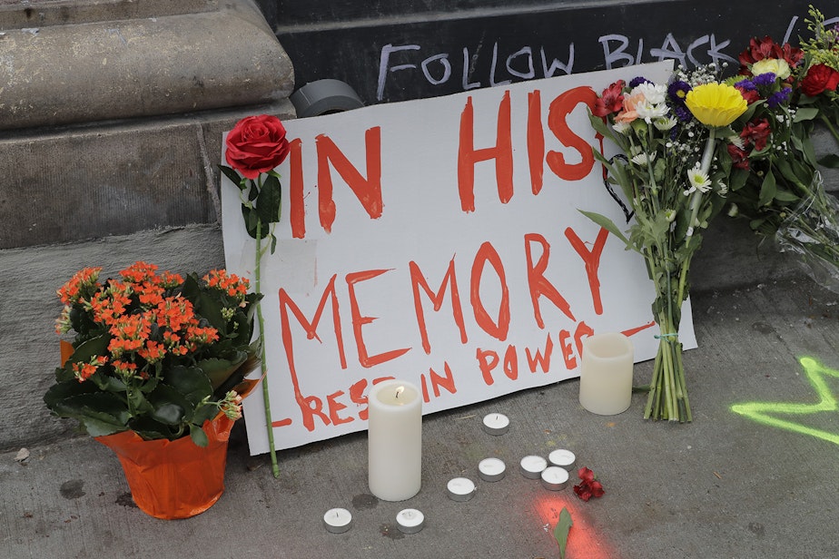 caption: A sign that reads "In his Memory Rest in Power," is displayed at a growing memorial to Lorenzo Anderson, Saturday, June 20, 2020, at the intersection of 10th Ave. and Pine St. near the Capitol Hill Occupied Protest zone in Seattle. 