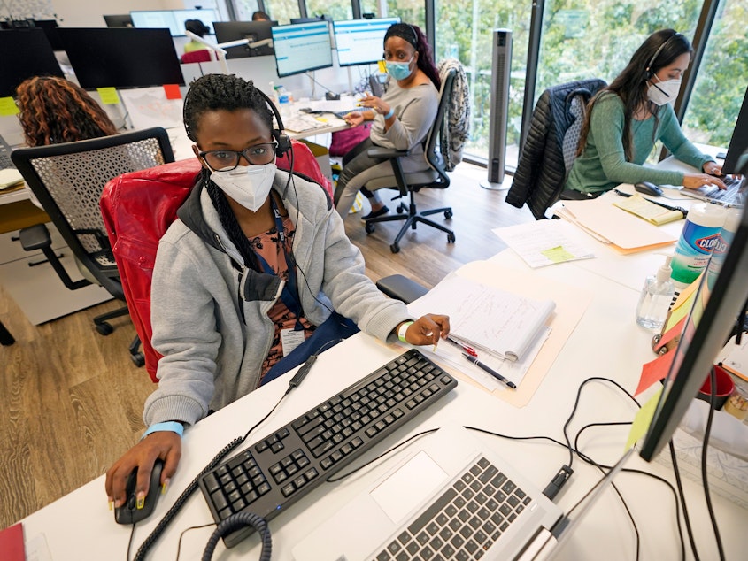 caption: From left to right; contact tracers Christella Uwera, Dishell Freeman and Alejandra Camarillo work at Harris County Public Health Contact Tracing facility in Houston, Texas, Thursday, June 25, 2020.