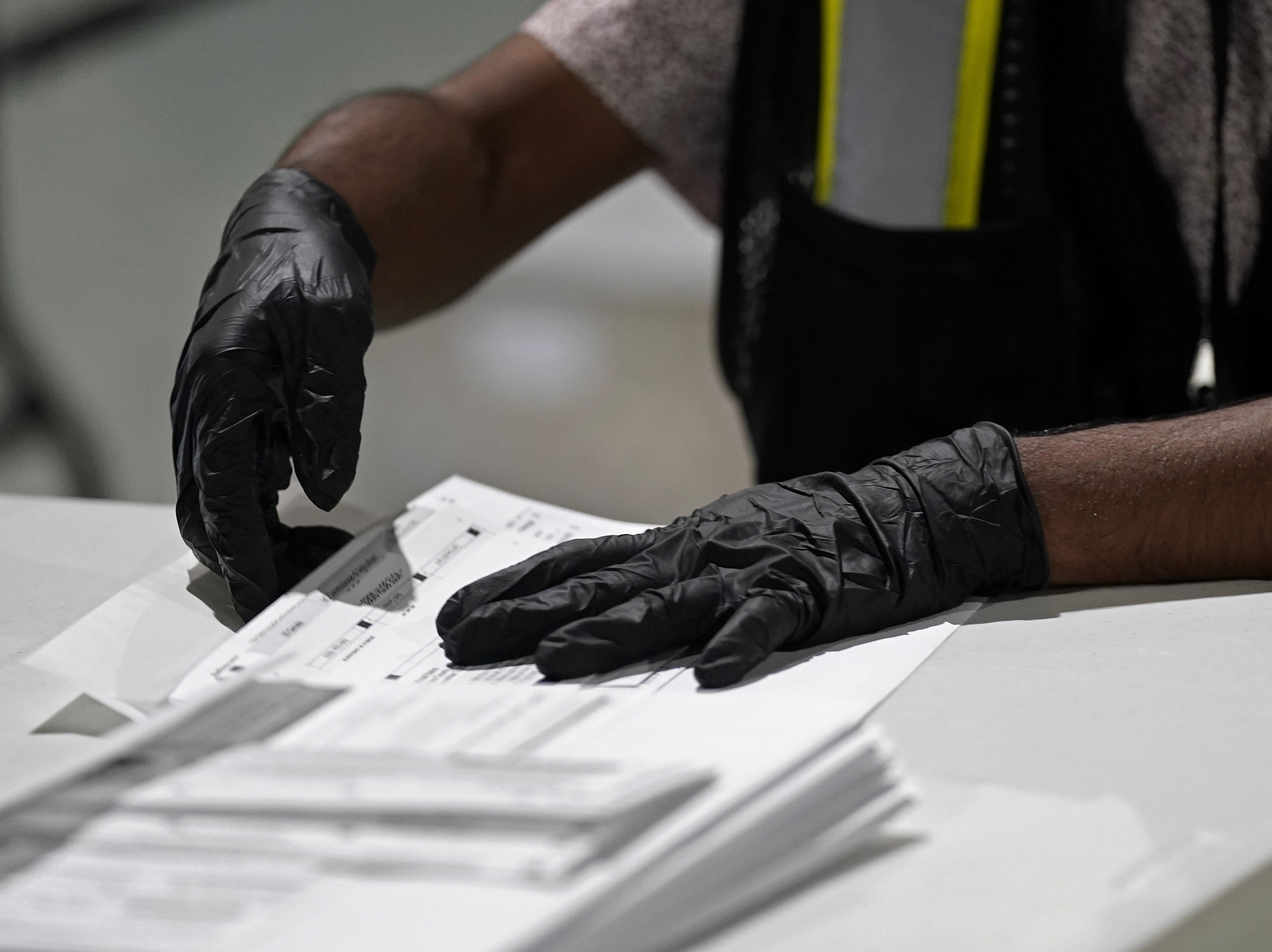 caption: A workers prepares absentee ballots for mailing at the Wake County Board of Elections in Raleigh, N.C., earlier this month.