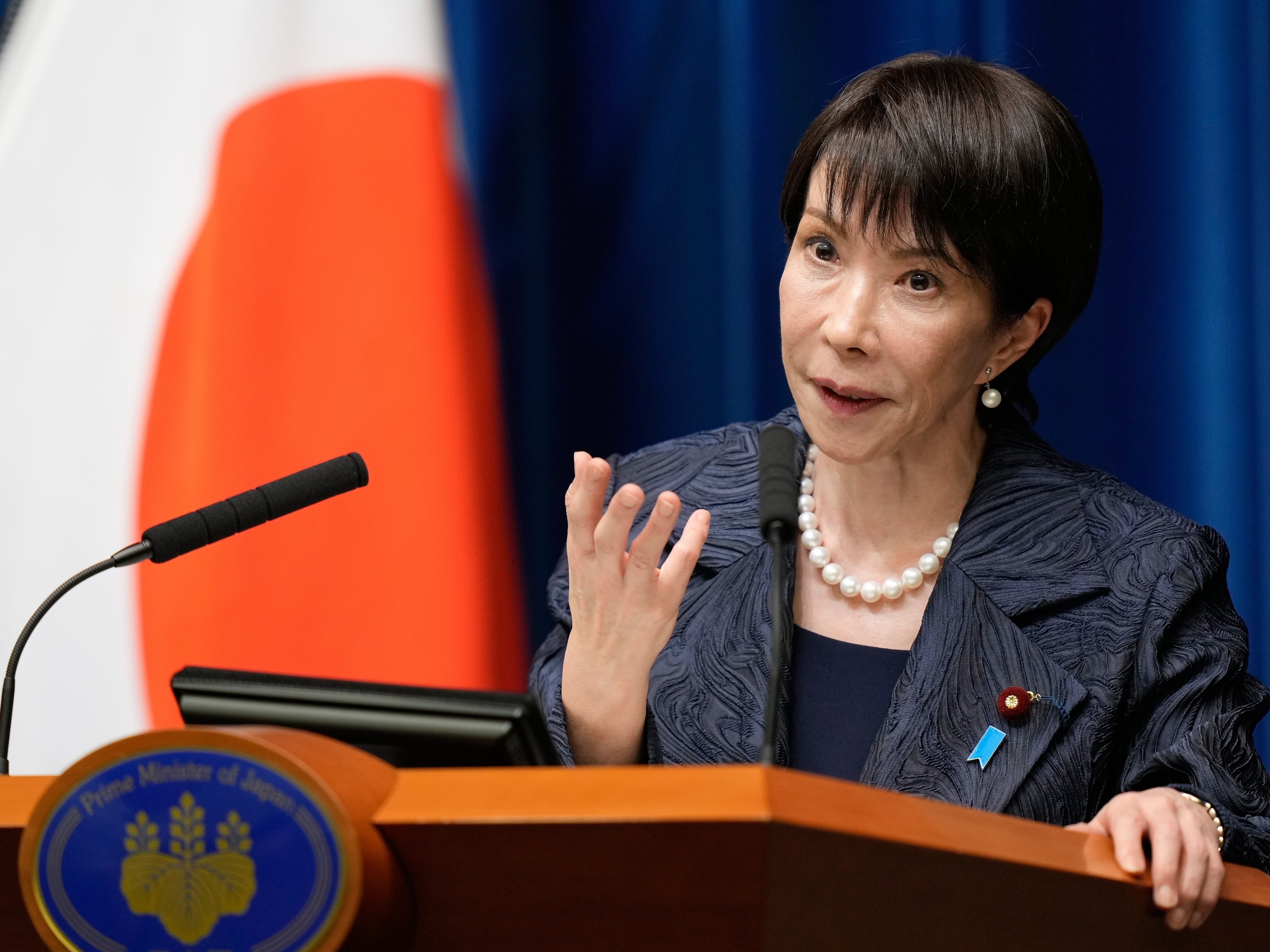 caption: Japan's new prime minister, Sanae Takaichi, speaks during a press conference at the prime minister's office in Tokyo, on Oct. 21.