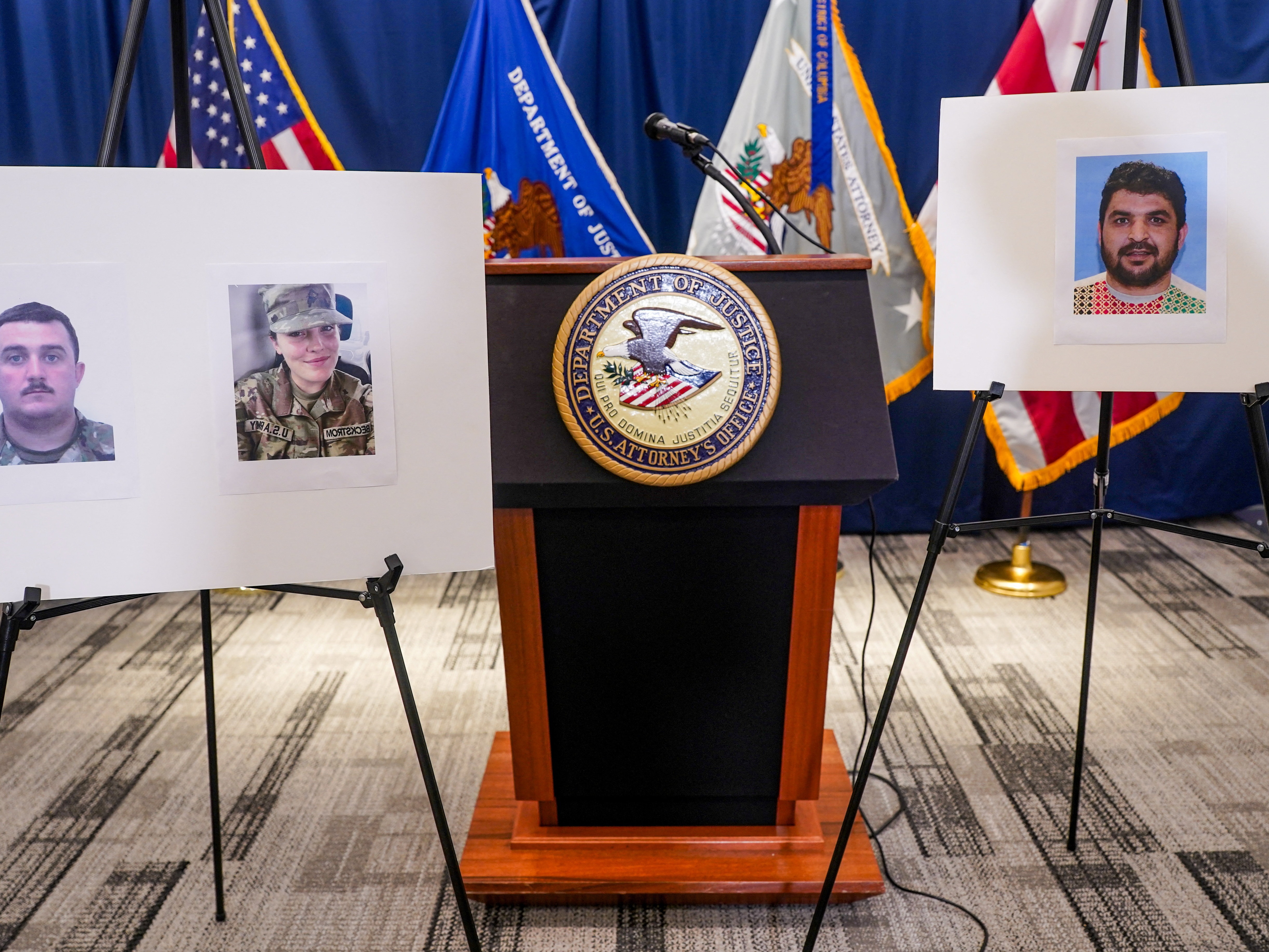 caption: Pictures of National Guard members Andrew Wolfe and Sarah Beckstrom, who were shot on Nov. 26 in Washington, D.C., are displayed next to a picture of the suspect in the shooting, Afghan national Rahmanullah Lakanwal, on the day of a news conference in Washington, D.C., on Nov. 27.
