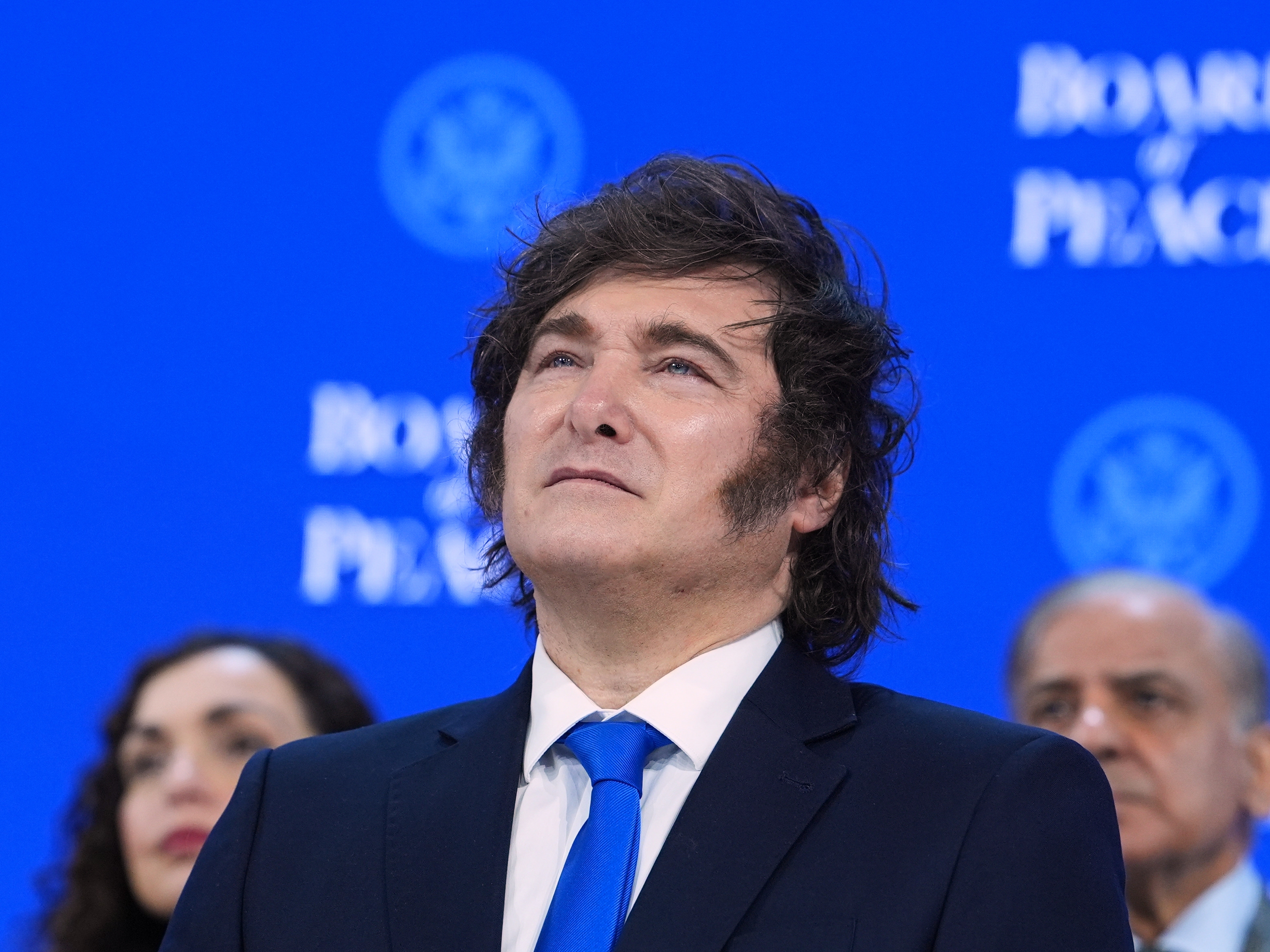 caption: Javier Milei, president of Argentina, listens to speeches after the signing of a Board of Peace charter during the annual meeting of the World Economic Forum in Davos, Switzerland, on Jan. 22.