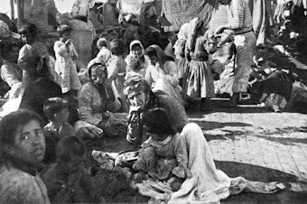 caption: Armenian refugees on the deck of the French cruiser that rescued them in 1915 during the massacre of the Armenian populations in the Ottoman Empire.
