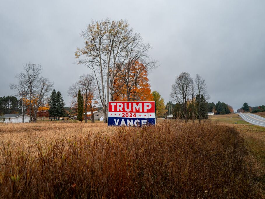 caption: A Trump-Vance campaign sign is displayed in a field on Oct. 25 in Kalkaska, Michigan.