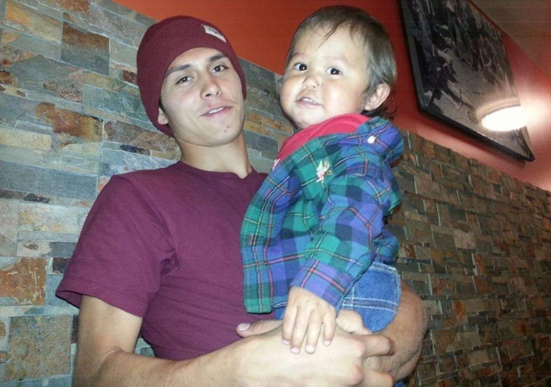 caption: Ivan Howtopat holding his nephew in an undated photo. Klickitat County put their jail under new leadership after Howtopat, age 24,  died there in May 2023 while experiencing opioid withdrawal. 