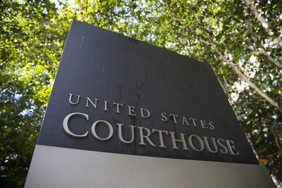 caption: The U.S. District Court sign is shown on Thursday, August 17, 2023, along Stewart Street in downtown Seattle.
