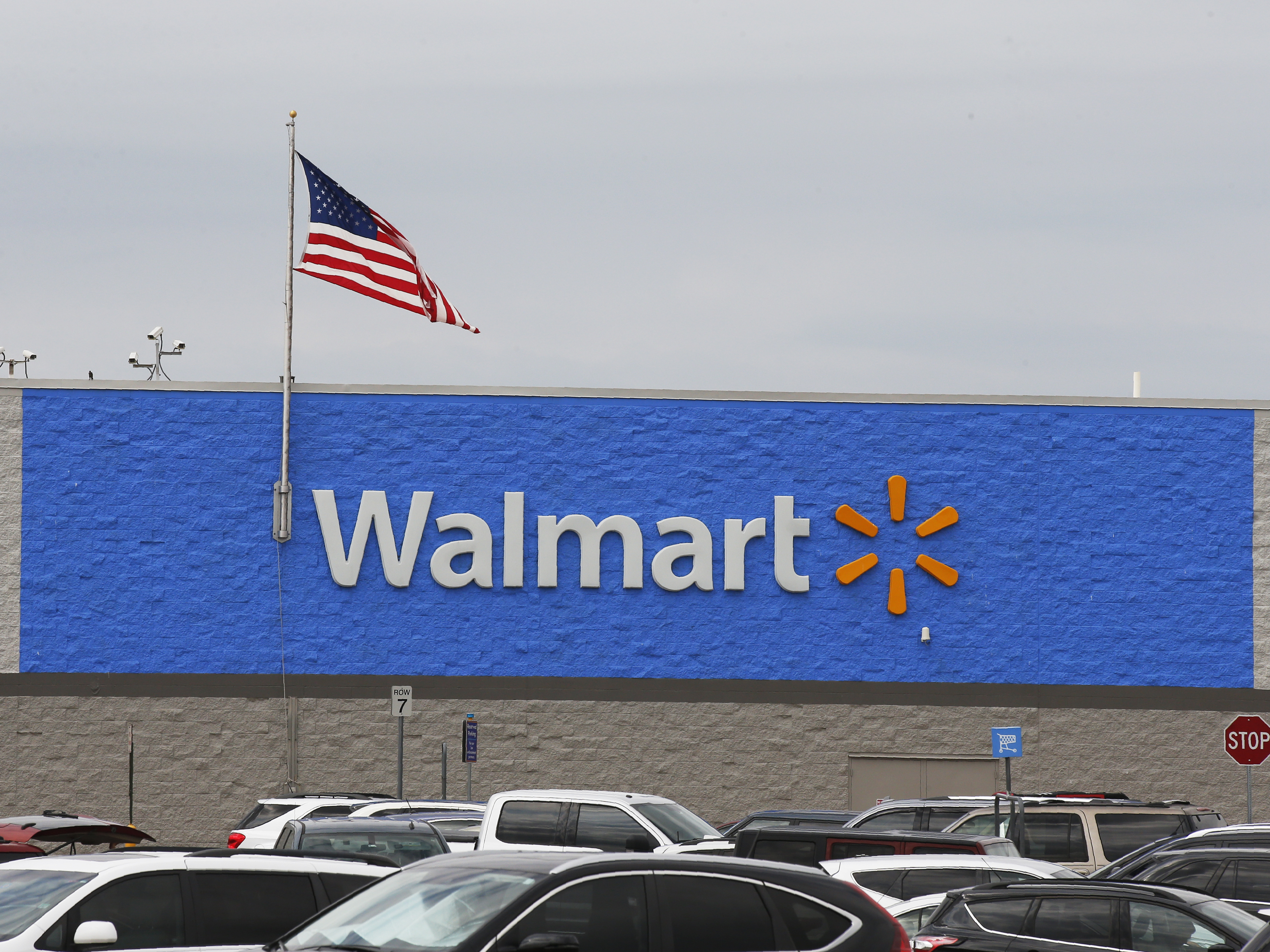 A U.S. flag waves over a Walmart parking lot in Oklahoma City on Aug. 4. The company sells firearms in about half of its 4,700 stores in the U.S.