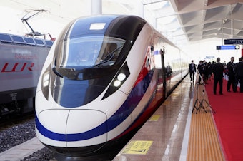 caption: A train is ready on the station during the handover ceremony of the high-speed rail project in Vientiane, Laos, connecting the city with Kunming, China, on Dec. 3, 2021.