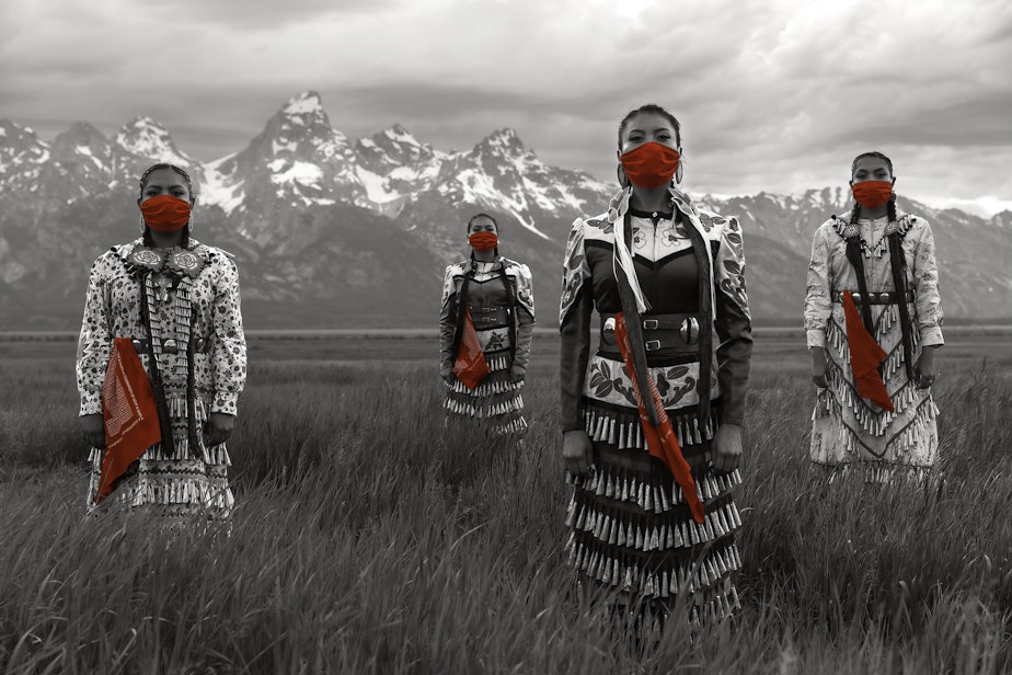 caption: Erin and Dion Tapahe, far left and right, and Sunni and JoAnni Begay, center, pose with red masks and scarves. The scarves pay homage to missing and murdered indigenous women.