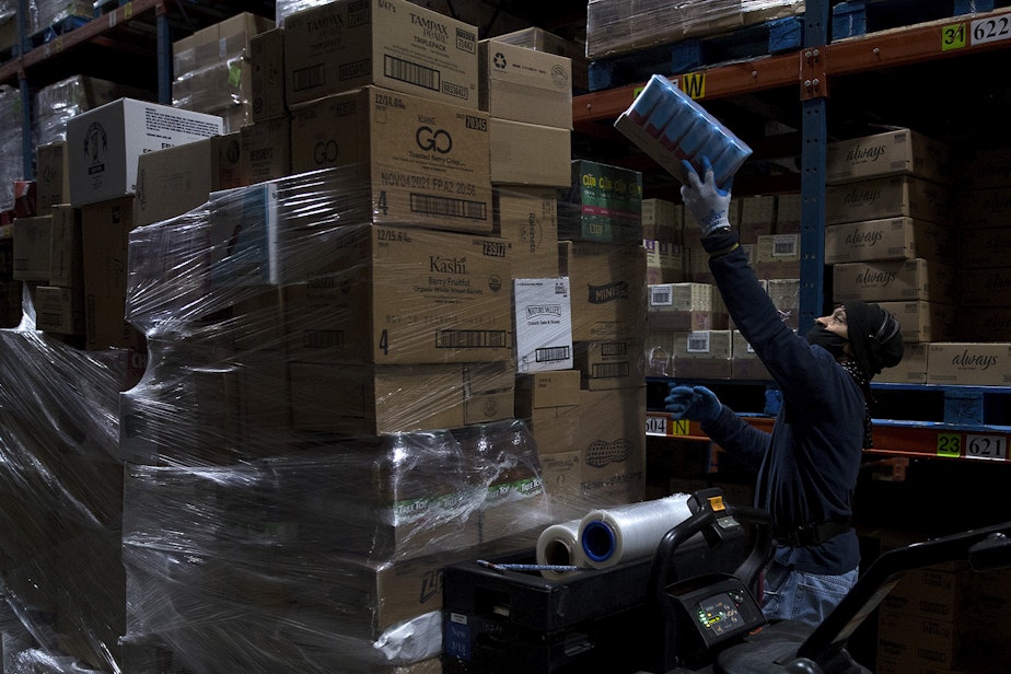caption: Monty Johnson, an order selector at Safeway's Distribution Center, works on Monday, March 22, 2021, at the center in Auburn. Grocery  workers became eligible to be vaccinated against Covid-19 on March 17.