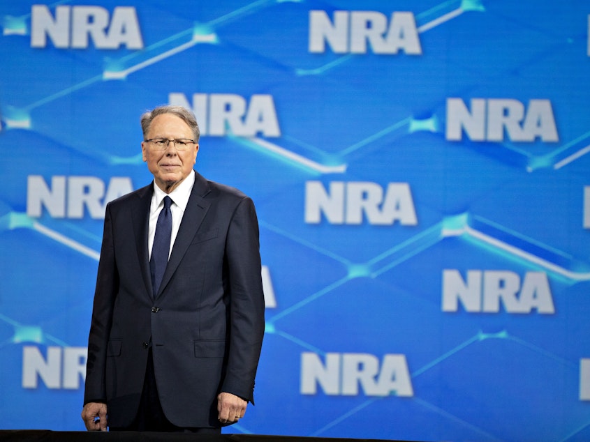 caption: Wayne LaPierre, CEO of the National Rifle Association, stands on stage during the NRA annual meeting in Indianapolis, on Friday, April 26, 2019.