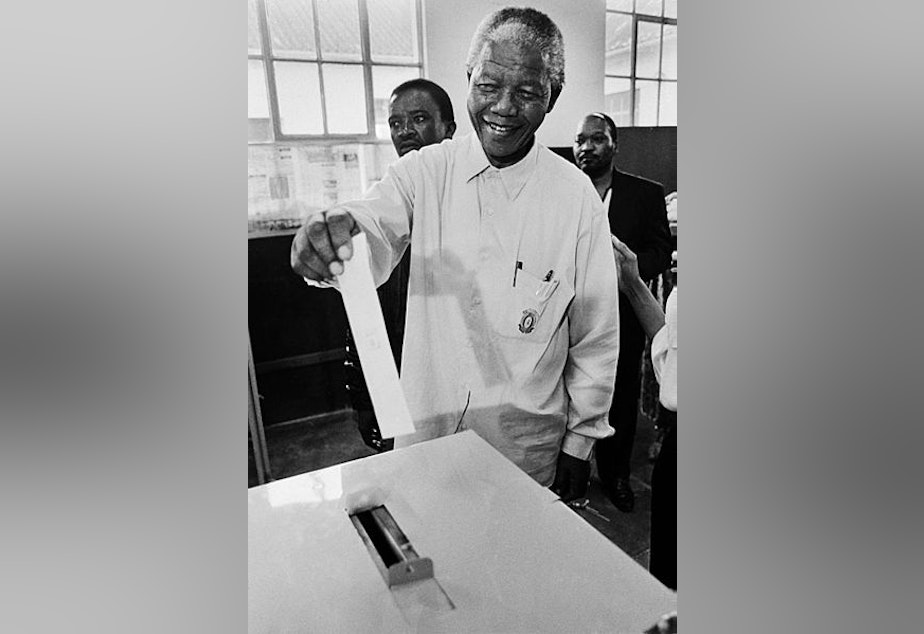 caption: Nelson Mandela casting his vote in 1994. He passed away yesterday at the age of 95.